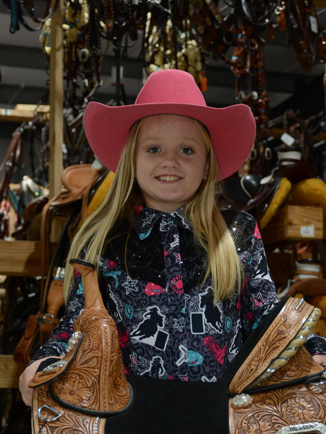 Barrel racer on palomino in Hilason western tack at championship rodeo
