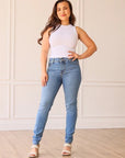 THE PARIS HIGH RISE LIGHT WASH SKINNY JEAN